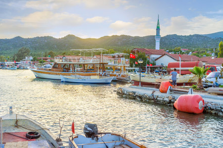 KEKOVA, TURKEY - MAY 7, 2017: The view on Kekova village with minaret of Ucagiz mosque through the port, on May 7 in Kekovaのeditorial素材
