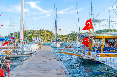 KEKOVA, TURKEY - MAY 7, 2017: The walk along the pier of port between tourist yachts, on May 7 in Kekovaのeditorial素材