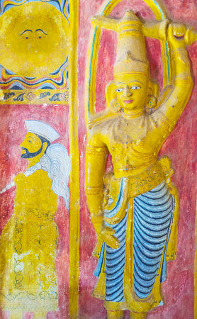 UDUNUWARA, SRI LANKA - NOVEMBER 29, 2016: The interior of Sanctum of Garagha in Embekka Dewalaya Temple with the painted sculpture of the ancient guardian, on November 29 in Udunuwara.のeditorial素材