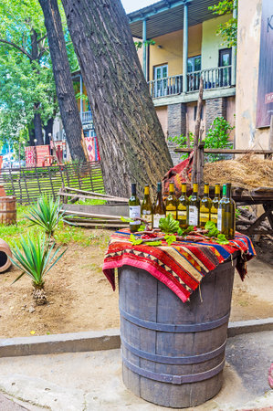 TBILISI, GEORGIA - JUNE 6, 2016: The barrel with wine bottles is the best commercial for traditional Georgian restaurant, on June 6 in Tbilisi.のeditorial素材