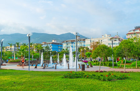 ALANYA, TURKEY - MAY 8, 2017: The juicy lawn of Abdurrahman Alaettinoglu park, the perfect place for the walks and relax with a view on the fountains, on May 8 in Turkey.のeditorial素材