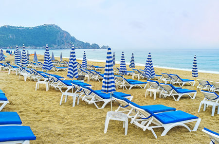Kleopatra beach is quiet and cozy early in the morning, the rows of sun beds wait for the tourists, Alanya, Turkey.のeditorial素材