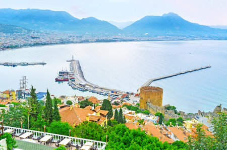 The Castle Hill on Alanya peninsula overlooks the port, coast of resort and the medieval Red Tower, located next to the historic shipyard, Turkey.のeditorial素材