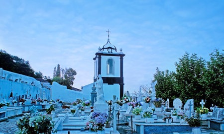 OBIDOS, PORTUGAL - APRIL 30, 2012: The evening view of the city cemetery with the bell tower of St John the Baptist Church on background, on April 30 in Obidos.のeditorial素材
