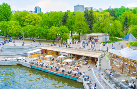 MOSCOW, RUSSIA - MAY 11, 2015: Cafe on embankment of Gorky Park offers wide range of beverages and dishes with great view on Moskva River, on May 11 in Moscow, Russiaのeditorial素材