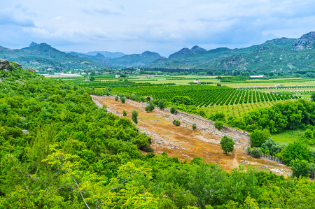 Aspendos hill overlooks the valley, covered with agriculture lands, neighboring with archaeological site, Serik, Turkey.の写真素材