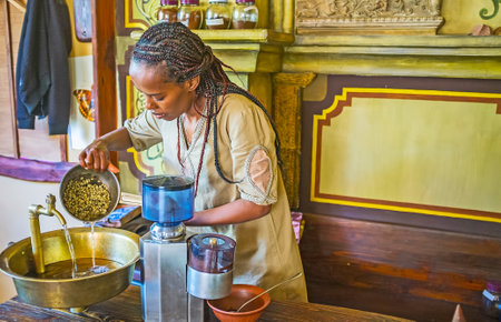 KIEV, UKRAINE - JUNE 4, 2017: Preparing for coffee ceremony - Ethiopian Tigrayan woman washes green coffee beans before the roast, on June 4 in Kiev.のeditorial素材