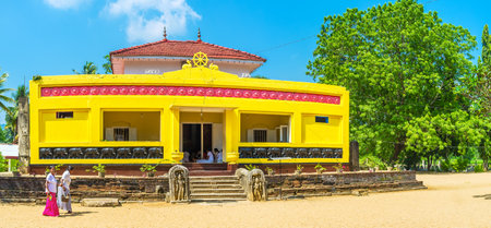 OKKAMPITIYA, SRI LANKA - DECEMBER 2, 2016: The view on Dematamal vihara temple with worshipers sitting in prayer hall, on December 2 in Okkampitiyaのeditorial素材