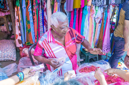 WELLAWAYA, SRI LANKA - DECEMBER 2, 2016: Brisk trading in candy stall, merchant offers variety of candies, that are the popular sweet in Sri Lanka , on December 2 in Wellawayaのeditorial素材