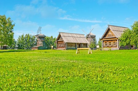 Enjoy traditional log izba peasant houses and historic windmills among the greenery of Suzdal museum of wooden architecture, Russia.のeditorial素材