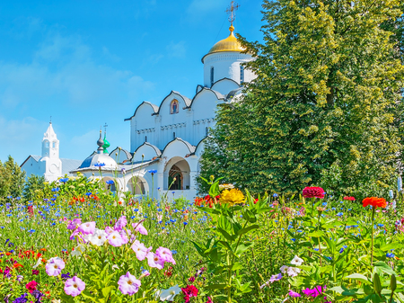 The old cathedral of Intercession Monastery with colored wildflowers on the foreground, Suzdal, Russia.の写真素材