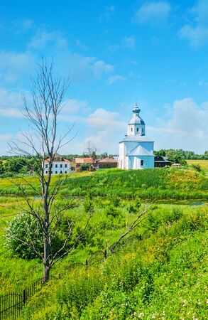 The view from historic shaft of Suzdal Kremlin on the small church of Ilya the Prophet, standing on the opposite bank of Kamenka river, Russia.の写真素材