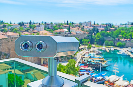 The coin-operated binocular helps to discover old Kaleici district in details, enjoy its architecture, port with ships and landscape of coastal area, Antalya, Turkey.の写真素材