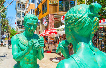 ANTALYA, TURKEY - MAY 13, 2017: The modern statues in Ataturk Boulevard - people in antique clothes conducts the television report, on May 13 in Antalya.のeditorial素材