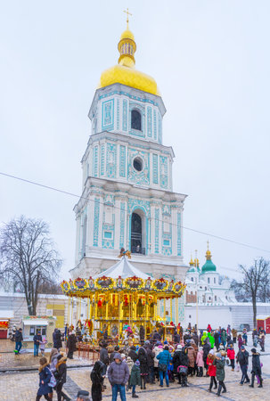 KIEV, UKRAINE - JANUARY 4, 2017: St Sophia Square is the main destination of Christmas festivity, here locates Christmas Tree, Market stalls, carousels and attractions for kids, on January 4 in Kiev.のeditorial素材