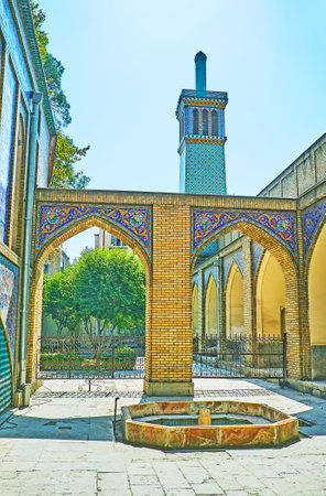 The small fountain at the corner of Emarat-e Badgir (Windcatchers Building) with the garden and wind tower on the background, Golestan, Tehran, Iran.のeditorial素材