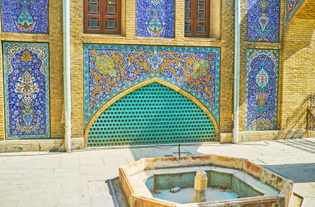 TEHRAN, IRAN - OCTOBER 11, 2017: The complex tiled patterns on the side wall of Emarat-e Badgir (Wind Towers Building) of Golestan, facing the small fountain yard, on October 11 in Tehran.のeditorial素材