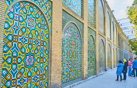 TEHRAN, IRAN - OCTOBER 11, 2017: The tourists make pictures of picturesque wall in Golestan complex,...