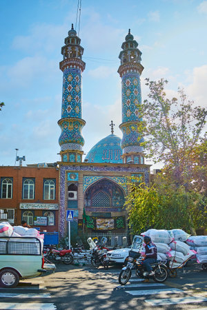 TEHRAN, IRAN - OCTOBER 11, 2017: Chaotic traffic in Panzdah-e Khordad street with a view on scenic Al-Aqa (Al-Agha) mosque with bright blue dome and minarets, on October 11 in Tehran.のeditorial素材