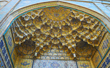 Decorative details of the entrance portal (iwan) of the Shah's Mosque with relief semi-dome and complex tiled Persian patterns, Tehran, Iran.