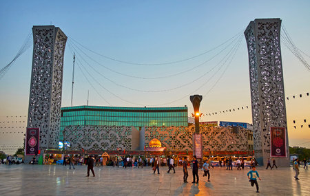 TEHRAN, IRAN - OCTOBER 11, 2017: The crowded Imam Hossein Square with a view on modern metal constructions, reminding the minarets, and the stalls, dedicated to Muharram Mourning and offering religious and historic literature, on October 11 in Tehran.のeditorial素材