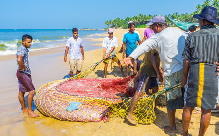 BENTOTA, SRI LANKA - DECEMBER 6, 2016: The process of traditional Sri Lankan fishing - fishermen...