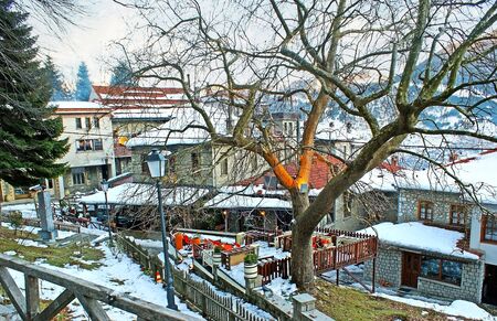 The tourist street of old Metsovo with the cozy family restaurants and taverns, offering best local cuisine, Greece.の写真素材