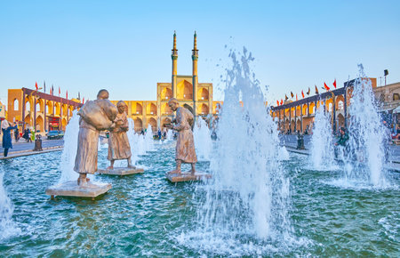 YAZD, IRAN - OCTOBER 17, 2017: The view on bronze sculptures of water carriers with Amir Chakhmaq complex on the background, on October 17 in Yazdのeditorial素材