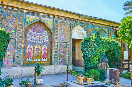 SHIRAZ, IRAN - OCTOBER 12, 2017: The garden of Naranjestan complex is surrounded with tall wall, covered with rich tiled patterns and pictures, on October 12 in Shiraz.のeditorial素材