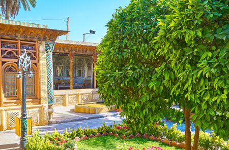 SHIRAZ, IRAN - OCTOBER 12, 2017: The scenic garden of Zinat Ol-Molk mansion with mirror veranda on the background, on October 12 in Shiraz.のeditorial素材