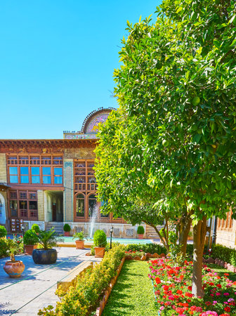 SHIRAZ, IRAN - OCTOBER 12, 2017: Zinat Ol-Molk mansion boasts scenic green garden with flower beds, plants in pots, citrus trees and fountains, on October 12 in Shiraz.のeditorial素材