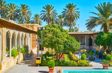 SHIRAZ, IRAN - OCTOBER 12, 2017: The scenic garden of historic Zinat Ol-Molk mansion with colorful flower beds, trimmed bushes and lush citrus trees, on October 12 in Shiraz.のeditorial素材