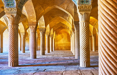 SHIRAZ, IRAN - OCTOBER 12, 2017: The scenic stone columns in Vakil Mosque are covered with carved...