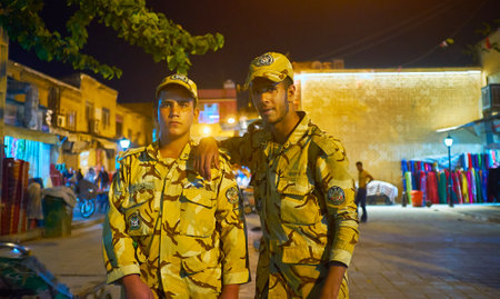 SHIRAZ, IRAN - OCTOBER 12, 2017: The young soldiers of Iranian Army pose for the portrait in the evening street of Bazar-e No, on October 12 in Shiraz.のeditorial素材