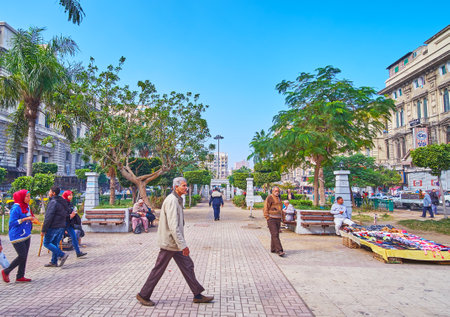 ALEXANDRIA, EGYPT - DECEMBER 17, 2017: The green park occupies the crowded El-Tahrir square, here are always many people and spontaneous market stalls, on December 17 in Alexandria.のeditorial素材