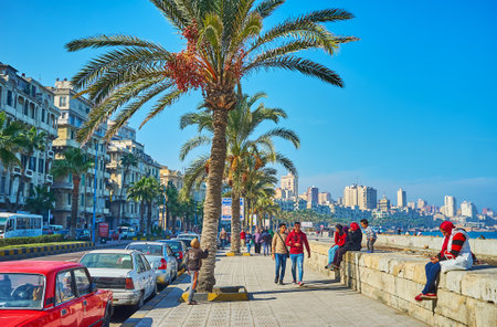 ALEXANDRIA, EGYPT - DECEMBER 17, 2017: The seaside walking area in Corniche avenue is the popular place among local students, spending their free time with friends there, on December 17 in Alexandria.のeditorial素材