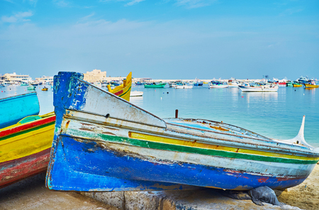 The old wooden boat of local fisherman waits for repair on shore of Eastern Harbor in historic part of Alexandria, Egypt.の写真素材
