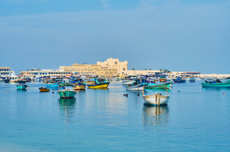 The view of Eastern harbor, full of small fishing boats, the medieval Qaitbay citadel is located on...