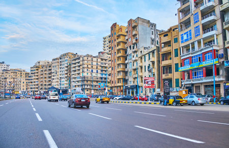 ALEXANDRIA, EGYPT - DECEMBER 17, 2017: Riding on El-Gaish road, stretching along the coast, here locate residential districts, numerous cafes and stores, on December 17 in Alexandria.のeditorial素材