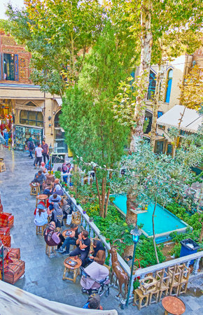 ISFAHAN, IRAN - OCTOBER 20, 2017: The small food court with garden and fountain is located in yard of Grand Bazaar in Nagsh-e Jahan square, on October 20 in Isfahan.のeditorial素材
