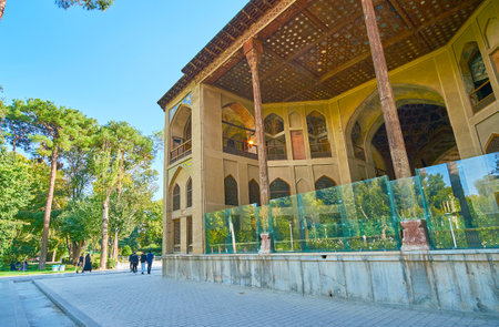 ISFAHAN, IRAN - OCTOBER 20, 2017: The  open air terrace of Hasht Behesht Palace is decorated with slender wooden pillar and carved ceiling, on October 20 in Isfahan.のeditorial素材