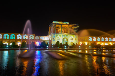 ISFAHAN, IRAN - OCTOBER 20, 2017: The evening view of Qapu Palace, located on Nagsh-e Jahan Square with gallery of Grand Bazaar on both sides, on October 20 in Isfahan.のeditorial素材