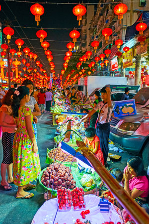 YANGON, MYANMAR - FEBRUARY 14, 2018: Locals and tourists enjoy the  the Spring Festival (Chinese New Year) celebration, visiting holiday market on Maha Bandula Road, on February 14 in Yangon.のeditorial素材