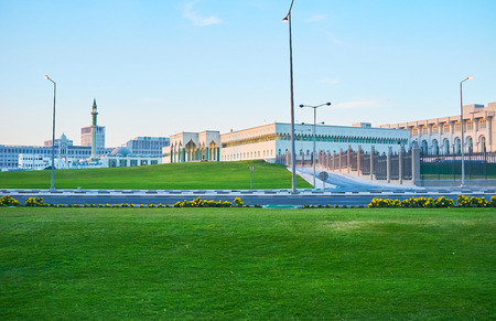 The view on Amiri Diwan government complex and Musheireb Mosque from the Corniche promenade, Doha,...