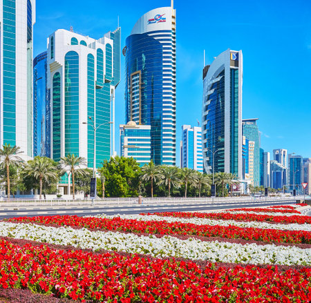 DOHA, CATAR - FEBRUARY 13, 2018: The flower beds are perfect decoration for the modern West Bay...