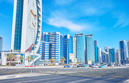 DOHA, QATAR - FEBRUARY 13, 2018: The view on glass skyscrapers of West Bay neighborhood from the Sheraton intersection - the wide roads of Corniche and Funduq streets, on February 13 in Doha.のeditorial素材