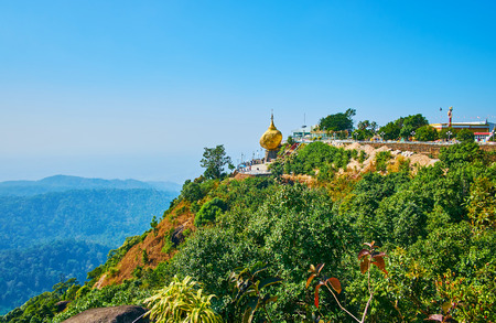 The Holy Kyaiktiyo Mount is topped with the granite Golden Rock, balancing at its edge on a strand of the Buddha's hair, Myanmar.の写真素材