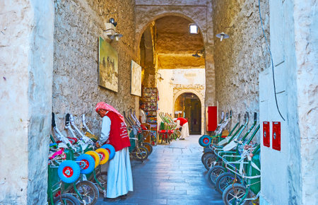 DOHA, QATAR - FEBRUARY 13, 2018: The narrow shady corridor in Souq Waqif is used by porters for keeping their wheelbarrows, on February 13 in Dohaのeditorial素材