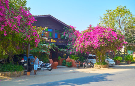 NEW BAGAN, MYANMAR - FEBRUARY 24, 2018: Small hotel with lush bushes of bougainvillea in front of the entrance, on February 24 in New Baganのeditorial素材