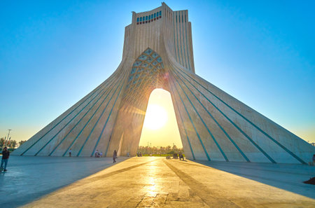 TEHRAN, IRAN - OCTOBER 24, 2017: Romantic evening view on Azadi Tower with bright rays of setting sun, on October 24 in Tehran.のeditorial素材